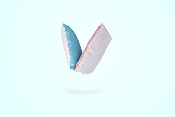 two orthopedic pillows over blue background, healthy, comfortable sleep concept