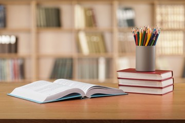 Stack school books with color pencil on desk