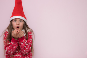 A portrait of a pretty young girl, girl blowing on her palms