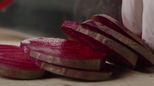 Cutting beet with sharp chef knife macro shot, cooking process, preparing ingredients for Tar Tar, slow motion, shot on Red Weapon Helium