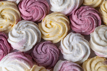 Background image. Homemade marshmallows with different flavors and pink, white, yellow colors.