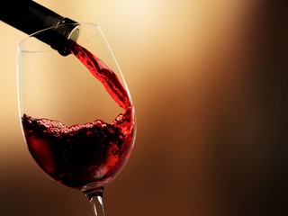 Pour red wine on blurred background