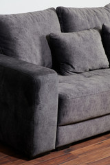 Grey sofa on wooden floor