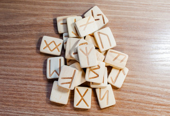 Stack of wooden fortune-telling runes on a wooden background. View from above. Fortune. Future.Selective focus.