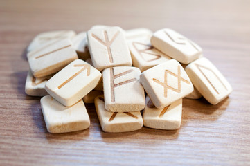 Stack of wooden fortune-telling runes on a wooden background. Fortune. Future. Selective focus.
