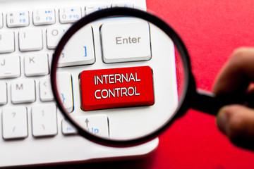 INTERNAL CONTROL word written on keyboard view with magnifier glass