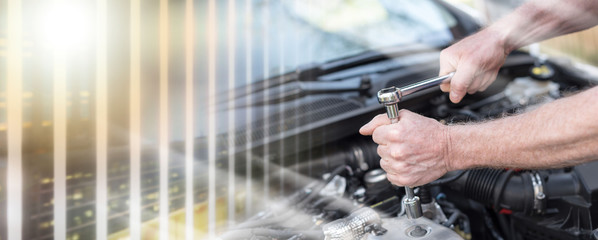 Hands of car mechanic working on car engine; multiple exposure