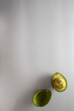half eaten avocado on a darkwhite background