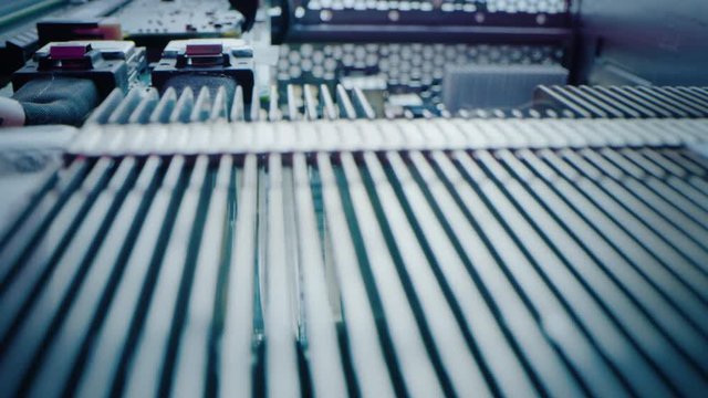 Macro Camera Moving Slowly over Printed Circuit Board, showing Computer Motherboard Components: Microchip, CPU Processor, Transistors