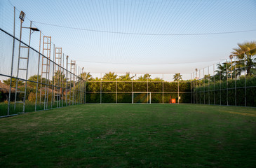Fenced soccer fiels or handball field with lights