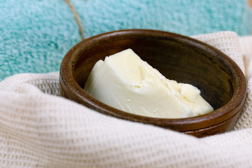 Cocoa butter chunk in a wooden bowl