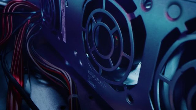 Close-up Macro Shot: Inside of the Computer Case. Camera Moves Alongside Row of Cooling Fans, with Multiple Power Cables Connected. Electronics Device Insides. Stylish Neon, Black, Pink, Blue Colors