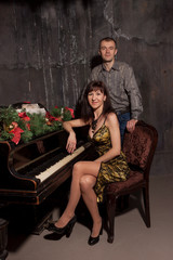 couple at the piano with Christmas decor	