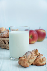 A glass of milk with homemade apple cookies. Cookies with apples. A glass of warm milk. Copy space. Dinner table. Healthy food balance.
