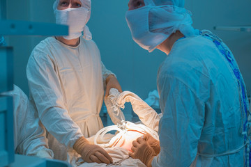 Close up of laparoscopic surgery in a sterile operating room. Percutaneous suturing of the inner...