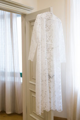 white wedding lace dress on a hanger