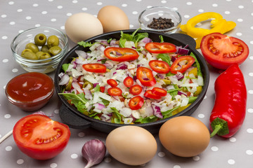 Set of vegetables for a healthy eating, yellow and red peppers, olives, tomatoes, onions, garlic. Sliced vegetables in pan. Top view. .