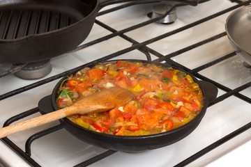 Vegetables stewed in pan on stove. Homemade food