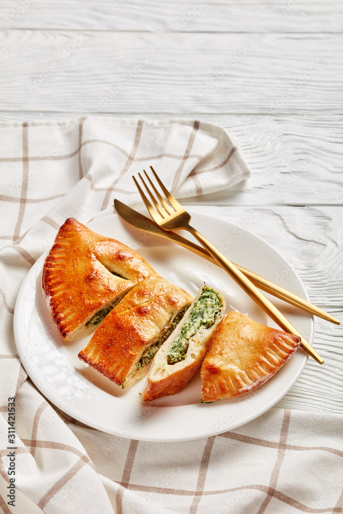 Wall mural freshly baked calzone with spinach and cheese