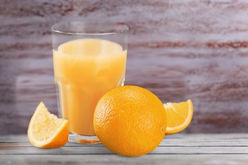 Orange juice and slices of orange fruit in glass