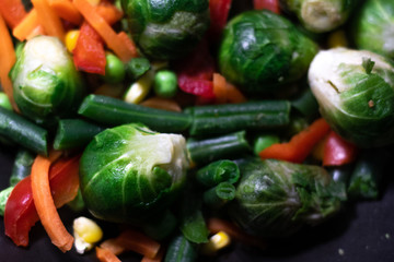 Vegetables: Brussels sprouts, broccoli, bell pepper, corn, carrots, peas, beans, onions. Grilled vegetables. Vegetables in a pan, stewed vegetables.