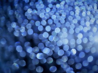  close-up of decorative abstract window surface after rain with blur / bokeh effect in classic blue color