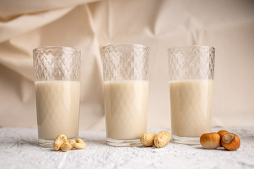 Three glasses with different types of organic milk. Nut milk without lactose, gmo, antibiotics and casein. Diet drink.