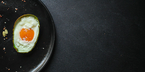 fried eggs in avocado (healthy food, vitamins) menu concept. food background. top view. copy space