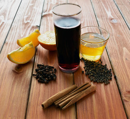 Glintwein of red wine with: orange, cinnamon, pepper, cloves and honey on a wooden background