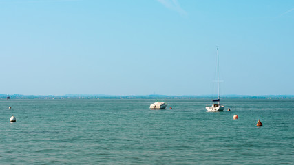 Fototapeta na wymiar Some empty yachts in a beautiful calm sea close to the shore