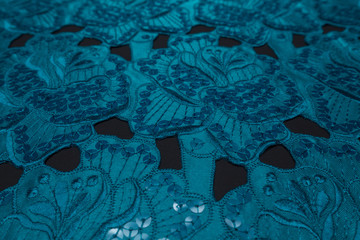 Beautiful closeup of blue lace fabric with textile texture background