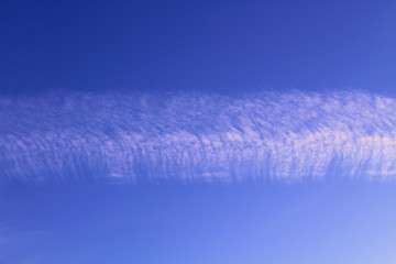 Contrail from an airplane in the sky. Close-up. Horizontal view. Background. Texture.