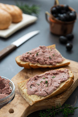 Fototapeta na wymiar Meat chicken or pork liver pate sandwich over wholgrainde bread slices, dark background. Copy space.