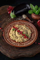 Healthy homemade creamy baked   eggplant caviar with spices, cream, tomatoes, pomegranate. Vegetarian food. Source of protein.