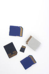  memory cards in blue, white and black on a white background. Flat lay