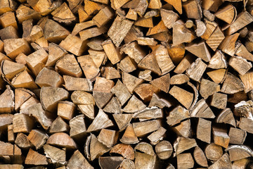 Stacked cut logs closeup. Background from cut birch firewood.