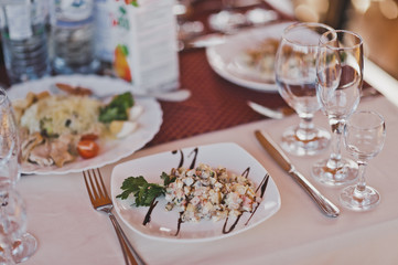 Place at the table with installed appliances and salad 2342.