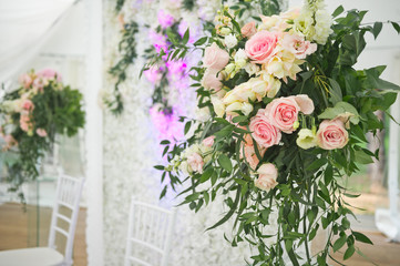 Elements of decoration of the festive hall in the form of bouquets of flow