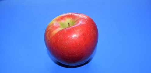 red apple on blue background