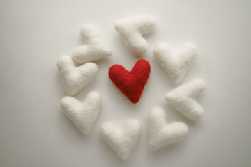 One red heart is surrounded by white hearts. Valentine's day background.