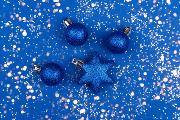 Shiny Christmas toys in blue. Christmas background color of the year classic blue 2020.