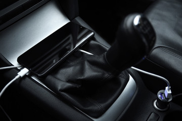 Obraz premium Mobile phone, smartphone charge battery , charging in the car plug close up