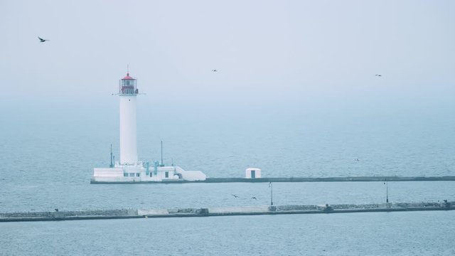 Lighthouse next to breakwaters in Odessa, Ukraine at dawn filmed with RED camera