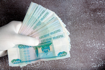 Hands in white gloves counting russian rubles. Recounting money.