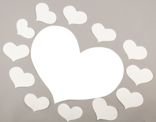 White paper hearts on grey background