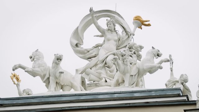 Victorious female statue with fearsome lions and gold painted torch RED Camera