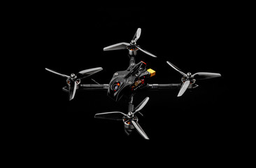 Modern FPV drone on a black background. Four-engine aircraft on the radio control. Drone for...
