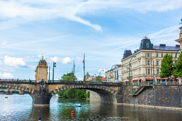 Prague embankment on a summer day. Panorama of the city. Beautiful buildings.