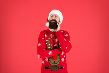 Get Guaranteed Christmas Delivery. winter holiday celebration. dreaming present. bearded man santa hat red wall. christmas time. male at xmas party. happy new 2020 year. funny hipster knitted sweater.