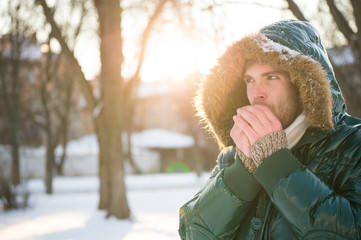 cold and loneliness. male in down coat with fur hood. feel warm and comfortable. favorite season. guy green puffer coat. man enjoy winter landscape. nature is beautiful. place for thoughts © be free